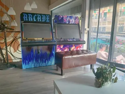 a video game exhibit with a couch in a room at SU SU khaosan hostels in Bangkok