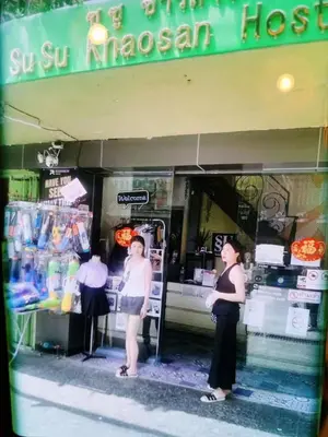 two women are standing outside of a grocery store at SU SU khaosan hostels in Bangkok