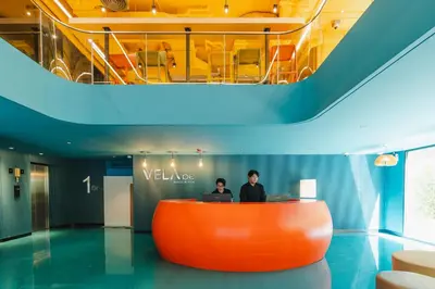two people standing at a reception desk in a building at VELA be Bangkok Siam in Bangkok