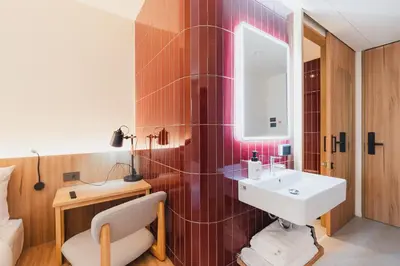 a bathroom with a sink and a mirror at VELA be Bangkok Siam in Bangkok
