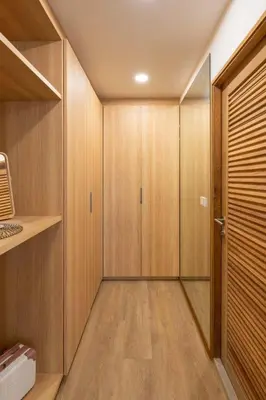 a walk in closet with wooden cabinets and a door at 3789 Elevator Villa in Bangkok