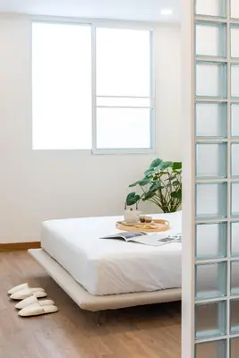a bedroom with a bed and two windows at 3789 Elevator Villa in Bangkok