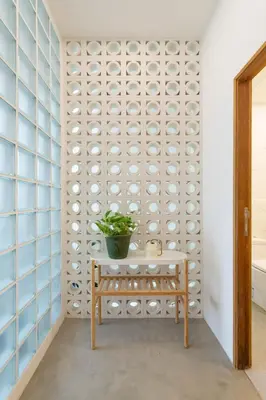 a room with a table and a wall of plates at 3789 Elevator Villa in Bangkok