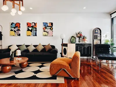 a living room with a couch and a table at 4BR Modern Art Villa with Free Wi-Fi Netflix Vinyl in Bangkok