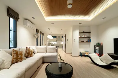 a living room with a white couch and a table at Asok house Sukhumvit27 Free BF in Bangkok
