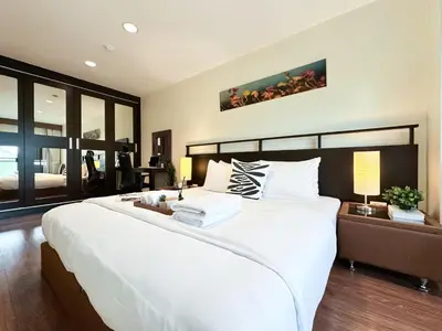 a bedroom with a large white bed and a large window at Vibrant Modern 57 SQM - Ultra Fast WiFi - BTS Thonglor in Bangkok