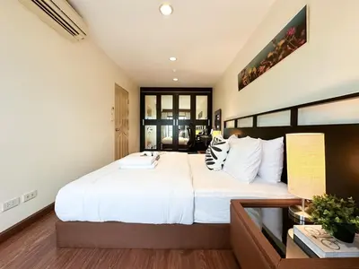 a bedroom with a large white bed and a window at Vibrant Modern 57 SQM - Ultra Fast WiFi - BTS Thonglor in Bangkok