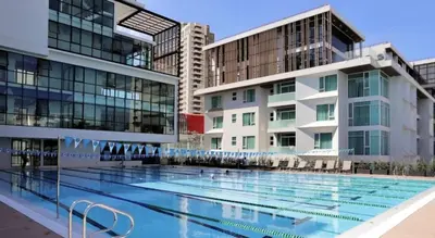 a large swimming pool in front of buildings at Vibrant Modern 57 SQM - Ultra Fast WiFi - BTS Thonglor in Bangkok