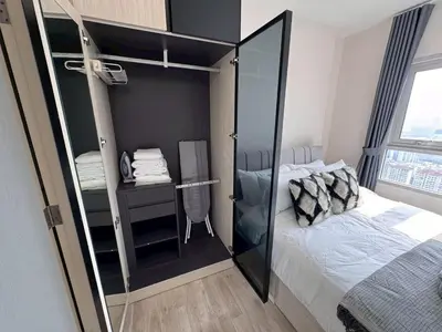 a bedroom with a bed and a glass wall at High Floor Luxury Studio with Great Views in Bangkok