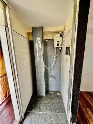 a corridor of a bathroom with a hose at Chubbi 5 Room24 in Ban Bang Bamru