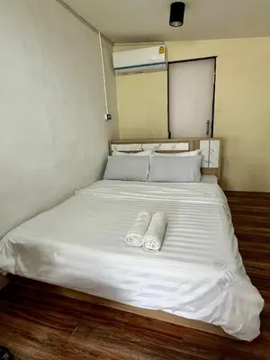 a large white bed with two towels on it at Chubbi 5 Room24 in Ban Bang Bamru