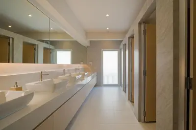 a bathroom with a row of sinks and mirrors at BEAT Warii Hostel at Chaophraya River in Bangkok