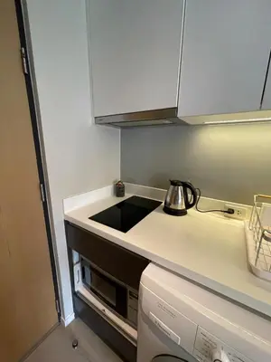 a small kitchen with a tea kettle on the counter at 4Pax MRT BTS Asoke, Terminal21 in Bangkok