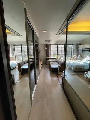 a room with two beds and a living room at 4Pax MRT BTS Asoke, Terminal21 in Bangkok
