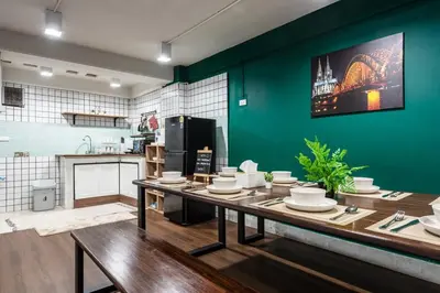 a kitchen with a table with plates on it at The Sleepyard Sathorn 11 in Bangkok