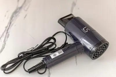 a rechargeable flashlight sitting on top of a table at 2 BR in Downtown BTS Chitlom BKK in Bangkok