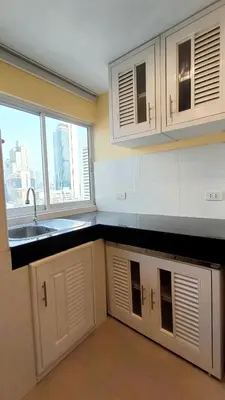 a kitchen with white cabinets and a sink and a window at Silom room 1bedroom with 2 Kings bed for 4 persons in Bangkok