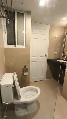 a bathroom with a white toilet and a sink at Silom room 1bedroom with 2 Kings bed for 4 persons in Bangkok