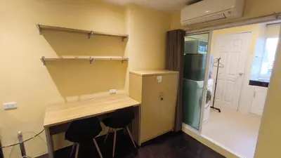 a room with a desk and a refrigerator at Silom room 1bedroom with 2 Kings bed for 4 persons in Bangkok