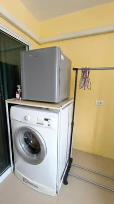 a washing machine with a tv on top of it at Silom room 1bedroom with 2 Kings bed for 4 persons in Bangkok