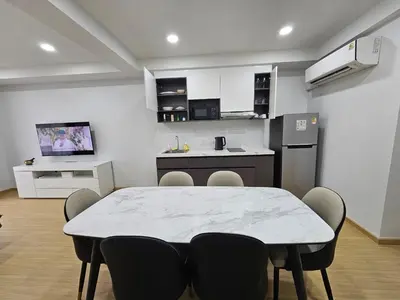 a kitchen and dining room with a table and chairs at SiS at Sathorn St Louis in Bangkok