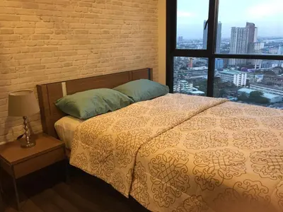 a bedroom with a bed and a large window at BRAND New Sukhumvit Condo Cozy BTS in Bangkok