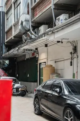 a black car parked in front of a garage at Lotus Bear House - 1BR Loft in Bangkok