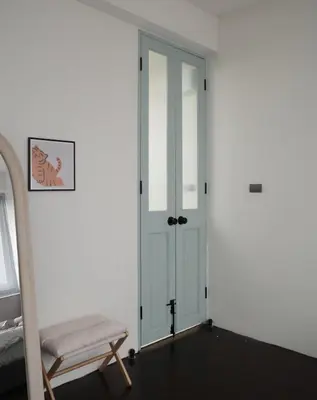 a room with a door and a chair in it at Charming 3BR Design Loft in the Heart of Ari in Sathani Bang Su