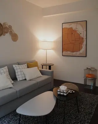 a living room with a couch and a table at Charming 3BR Design Loft in the Heart of Ari in Sathani Bang Su