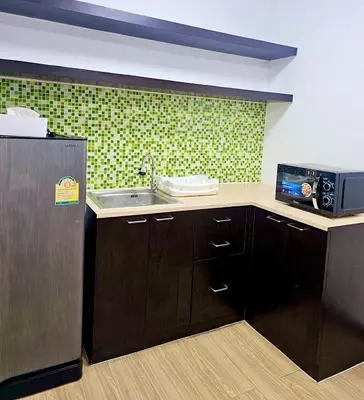 a kitchen with a sink and a refrigerator at KANYA Popular Condo in Ban Bang Phang