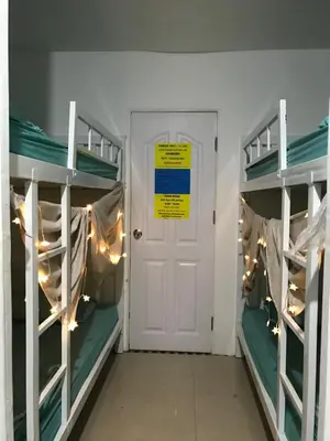 a room with two bunk beds and a door at 1sabai in Bangkok
