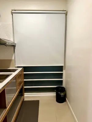 a room with a white screen in a kitchen at Serene Escape 2 mins from SRT Wat Samien Nari in Bangkok