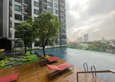 a swimming pool on the roof of a building at Beautiful condo, BTS Thonglor, 5mins by walking in Bangkok