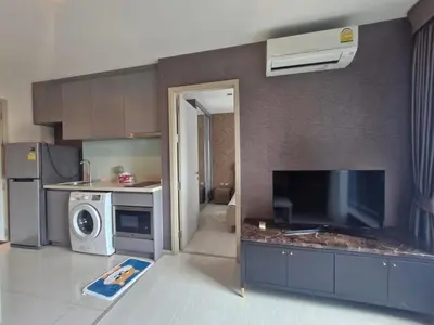 a kitchen with a tv and a kitchen with a microwave at Perfect condo, BTS Thong lo 5mins by walking in Bangkok