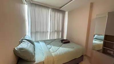 a small bedroom with a bed and a window at Lovely Condo-BTS Thong Lo 5mins in Bangkok