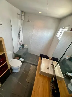 a bathroom with a toilet and a sink in it at Fab Rainbow Studio in Bangkok