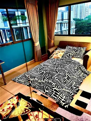 a bedroom with a bed with a zebra print at Fab Rainbow Studio in Bangkok