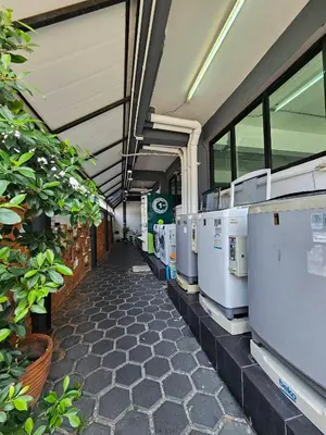 a row of washers and dryers in a building at Irich Residence Theparak S407 Bts-Chang Erawan 2kms in Ban Khlong Hua Sakae