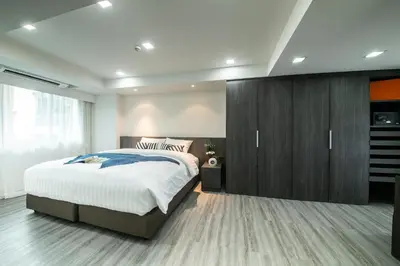 a bedroom with a large bed and wooden cabinets at Civic Park in Bangkok