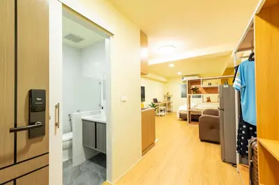 a small apartment with a kitchen and a living room at GL Sport Club Serviced Residence in Bangkok