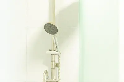 a shower with a shower head in a bathroom at GL Sport Club Serviced Residence in Bangkok