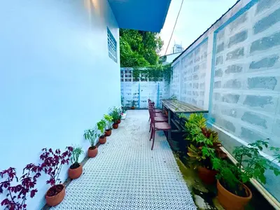a balcony with benches and potted plants on a building at Setthisin Art Boutique House,Iconsiam,BTS Thonburi in Godown