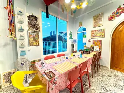 a dining room with a long table and chairs at Setthisin Art Boutique House,Iconsiam,BTS Thonburi in Godown