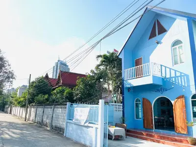 a blue and white house on the side of a street at Setthisin Art Boutique House,Iconsiam,BTS Thonburi in Godown