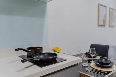 a kitchen with two pots and pans on a stove at 5 Star Sukhumvit Condo Infinity Pool Gym Sauna in Bangkok