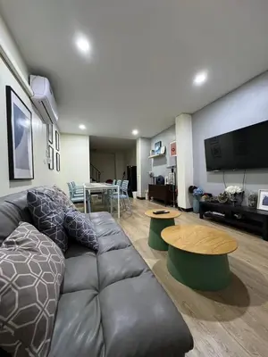 a living room with a couch and a table at GM6 - Samyan 4floors, 4mins walk to Bantadtong in Bangkok