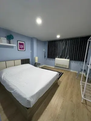 a bedroom with a large white bed and a window at GM6 - Samyan 4floors, 4mins walk to Bantadtong in Bangkok