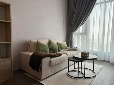 a living room with a couch and a table at Standardized at City View Condo near BTS Ratchathewi in Bangkok