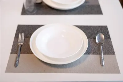 a white plate and fork and knife on a table at GM7 - Private House Downtown 2mins walk to metro in Bangkok