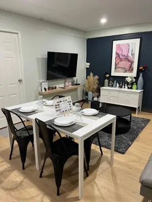 a dining room with a white table and black chairs at GM7 - Private House Downtown 2mins walk to metro in Bangkok